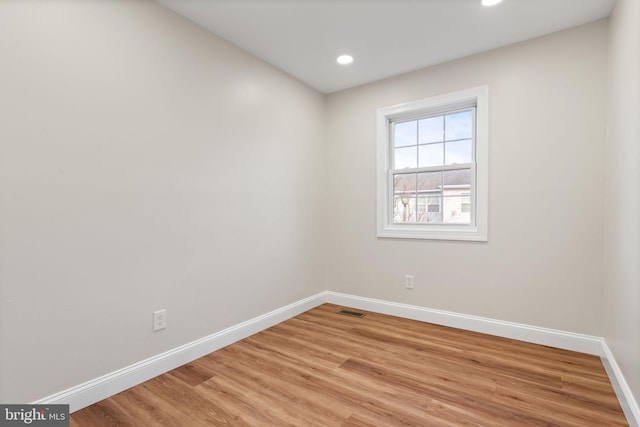 unfurnished room featuring visible vents, baseboards, light wood-style flooring, and recessed lighting