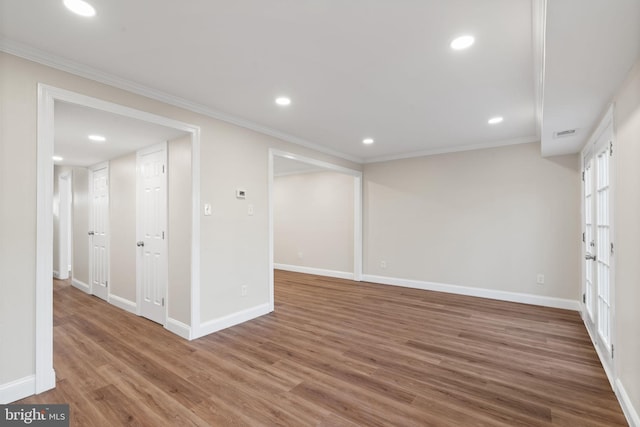 basement with recessed lighting, crown molding, baseboards, and wood finished floors