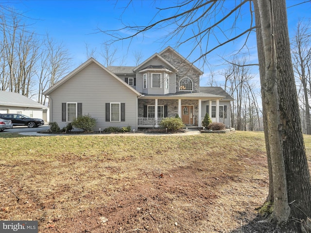 traditional-style home featuring covered porch and a front yard