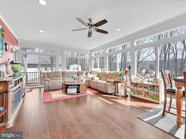 sunroom featuring ceiling fan