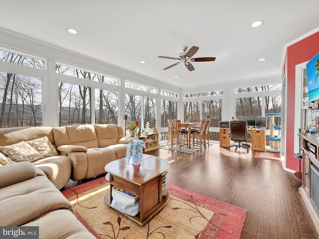 sunroom / solarium featuring a ceiling fan and a healthy amount of sunlight