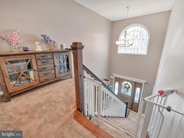 stairs featuring carpet, baseboards, and an inviting chandelier