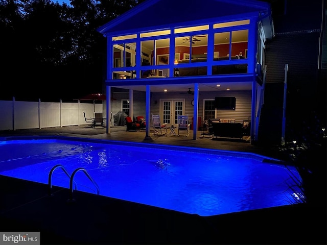 view of swimming pool featuring a fenced in pool, french doors, a ceiling fan, a patio area, and fence