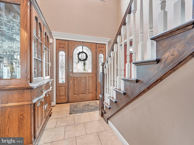 foyer entrance featuring stairs and light tile patterned flooring