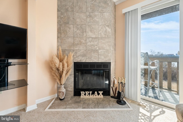 room details with visible vents, a fireplace, and baseboards