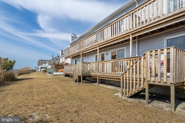 exterior space featuring a yard and a wooden deck