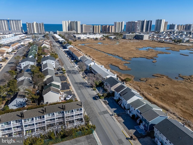 birds eye view of property with a water view and a city view