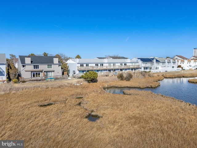 exterior space featuring a residential view and a water view