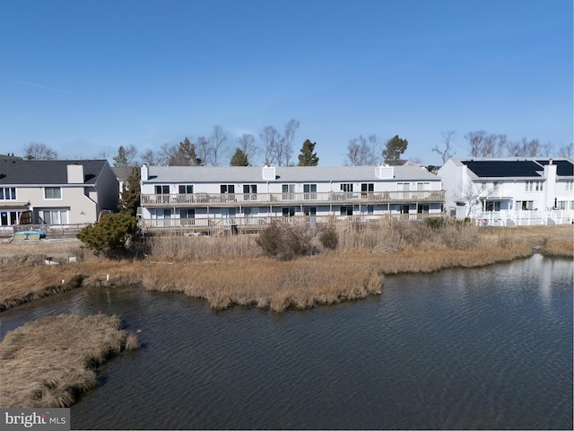 bird's eye view featuring a water view and a residential view