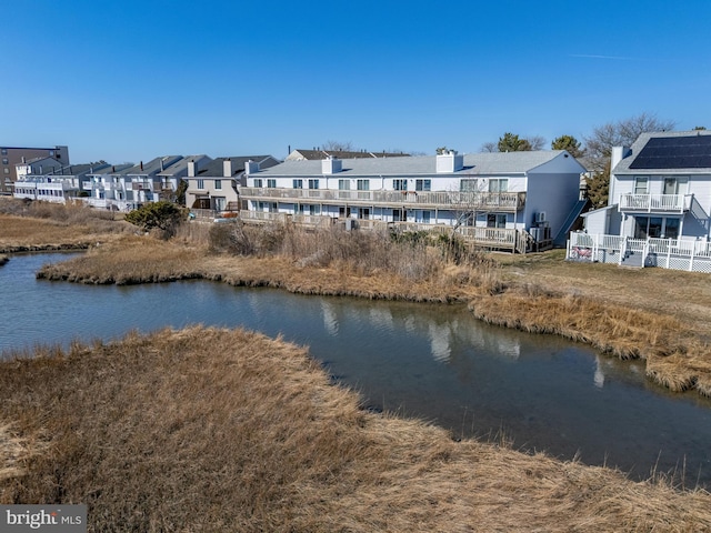 property view of water with a residential view and fence