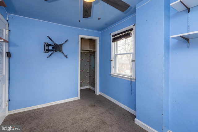 unfurnished bedroom with ceiling fan, carpet, and baseboards