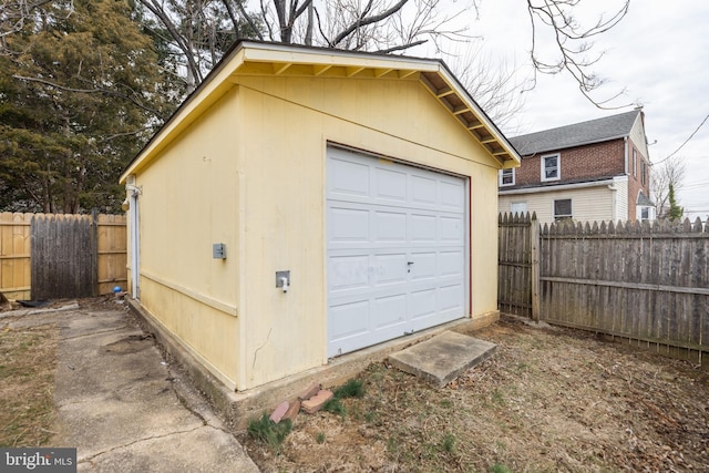 detached garage featuring fence