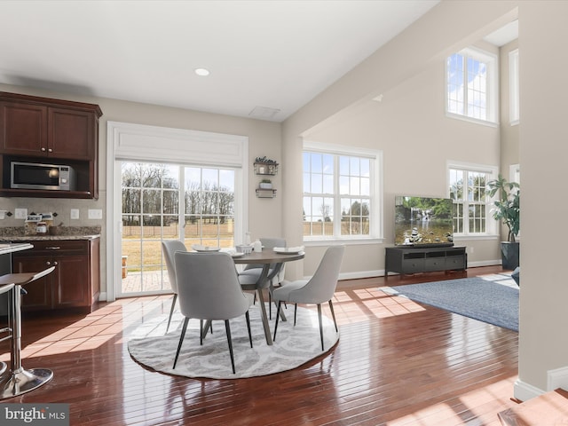 dining room featuring recessed lighting, baseboards, and hardwood / wood-style flooring