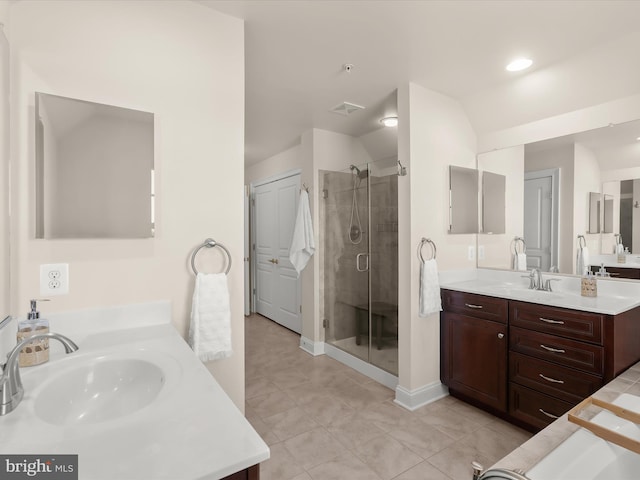 bathroom featuring a shower stall, two vanities, visible vents, and a sink