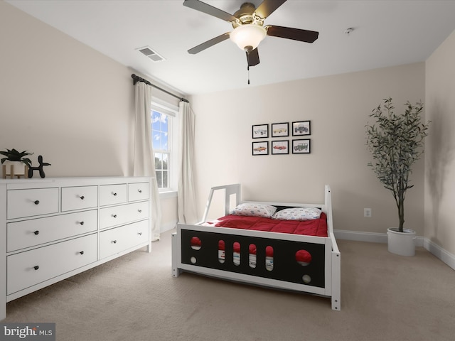 bedroom featuring visible vents, baseboards, light colored carpet, and ceiling fan