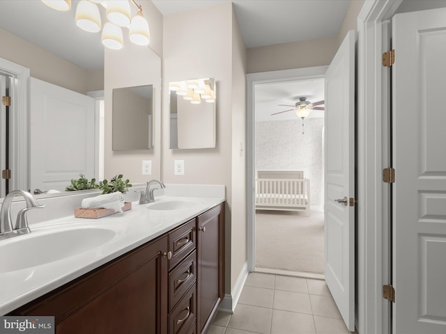 full bathroom with tile patterned flooring, double vanity, ceiling fan, and a sink