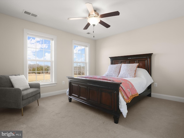 bedroom with light carpet, visible vents, ceiling fan, and baseboards