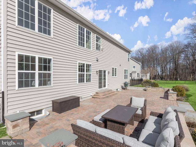 rear view of property featuring an outdoor living space, entry steps, and a patio