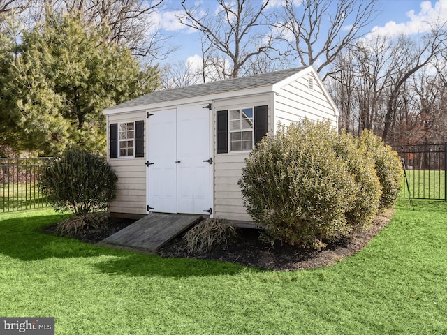 view of shed featuring fence