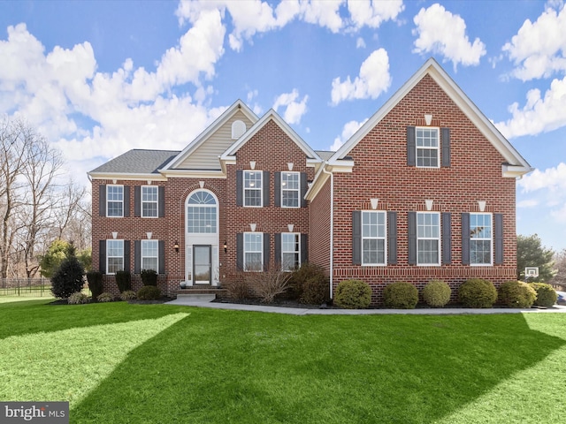 view of front of property with brick siding and a front yard