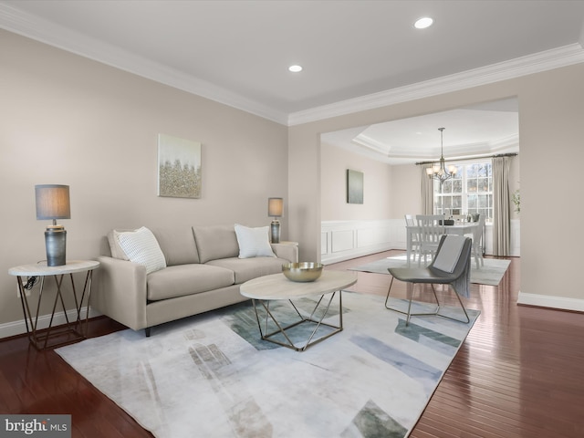 living room featuring recessed lighting, a notable chandelier, crown molding, and hardwood / wood-style flooring