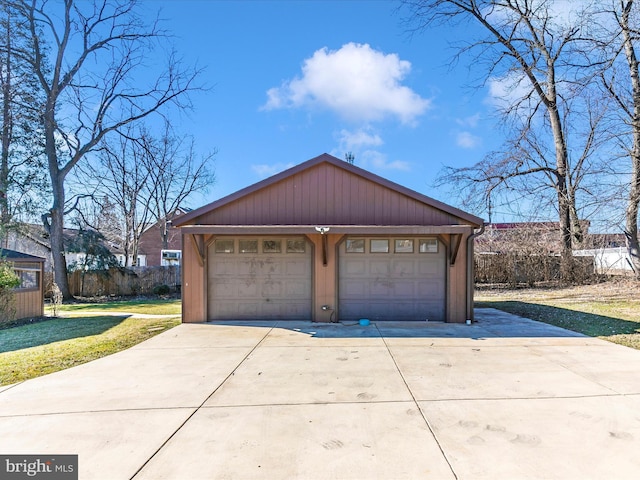 detached garage featuring fence