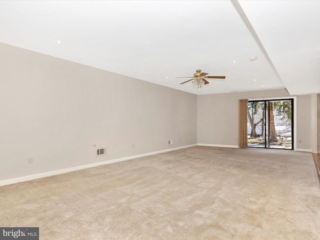 unfurnished living room with baseboards, ceiling fan, visible vents, and light colored carpet