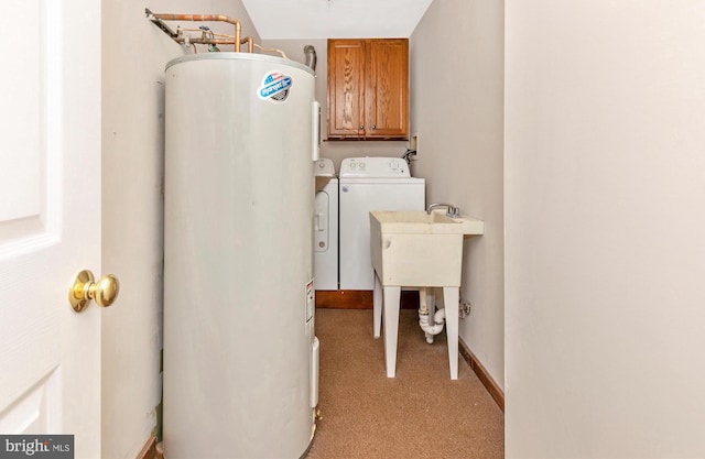 laundry room featuring washing machine and clothes dryer, light colored carpet, water heater, cabinet space, and baseboards