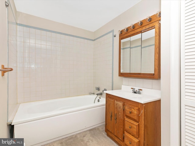 bathroom with vanity and a washtub