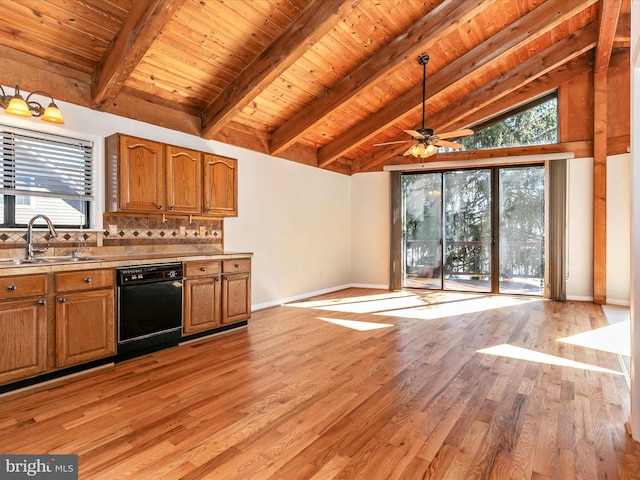 kitchen featuring brown cabinetry, black dishwasher, a healthy amount of sunlight, and a sink