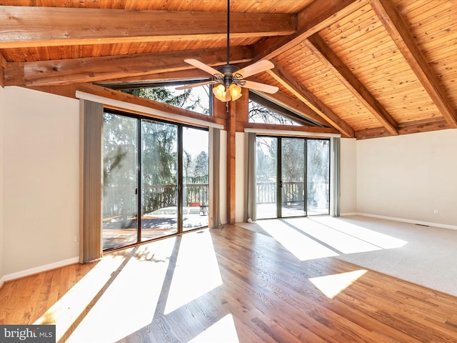 interior space featuring beam ceiling, a healthy amount of sunlight, and baseboards