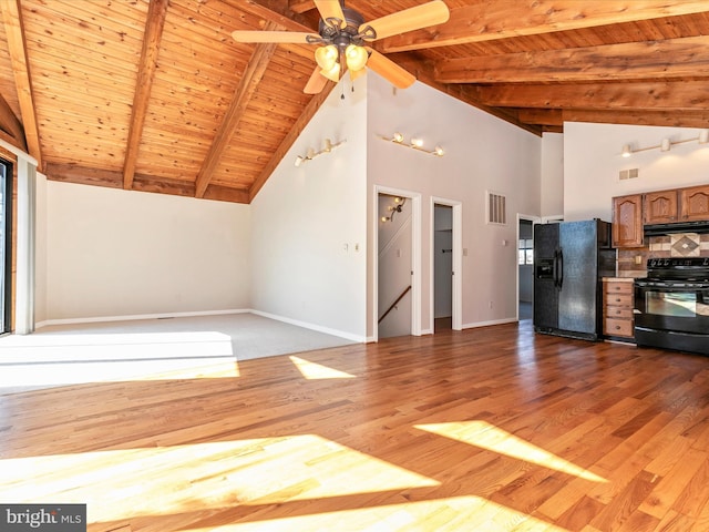 kitchen with black appliances, baseboards, visible vents, and extractor fan