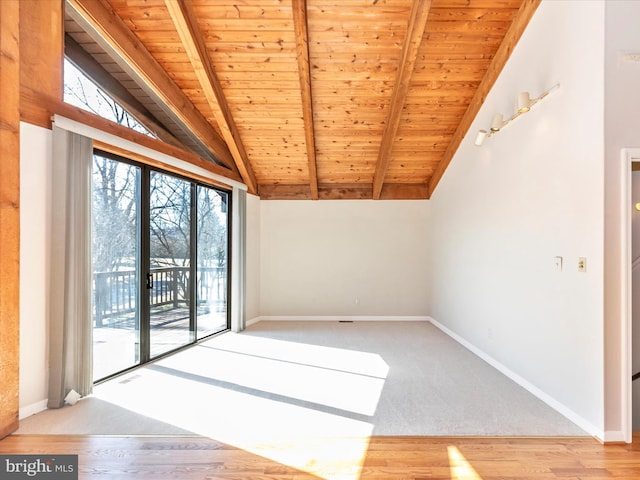 interior space with vaulted ceiling with beams and baseboards