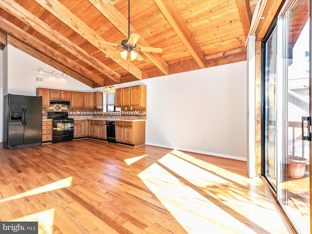 kitchen featuring light wood-type flooring, wood ceiling, vaulted ceiling with beams, and black appliances