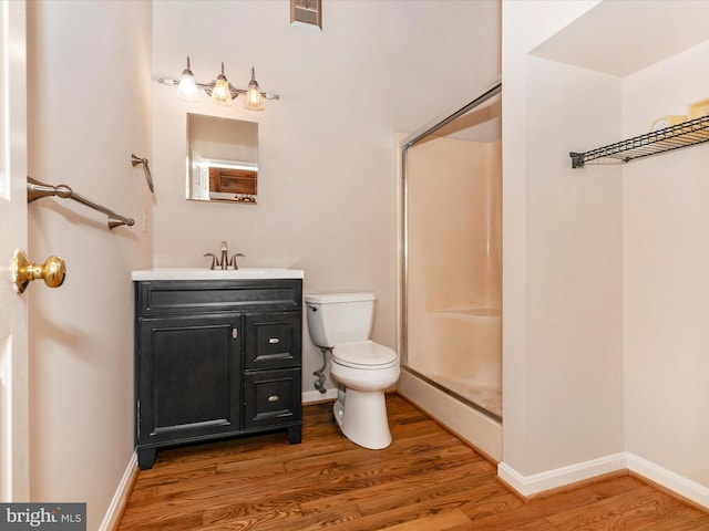 full bath featuring toilet, visible vents, a shower, and wood finished floors