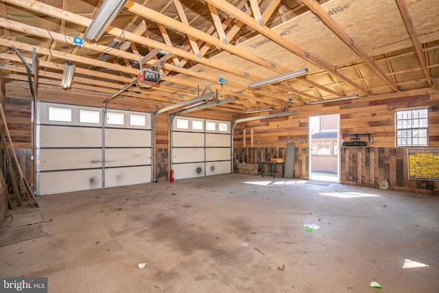 garage featuring wooden walls and a garage door opener