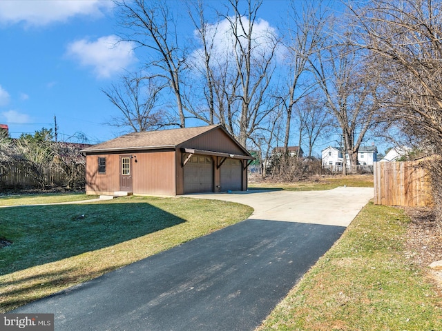 detached garage featuring fence