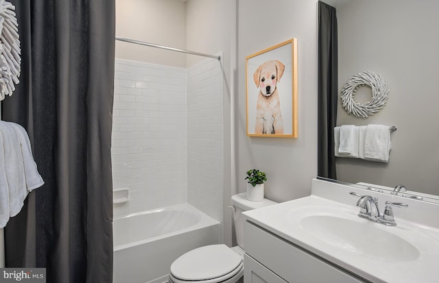 bathroom with toilet, shower / bath combo, and vanity