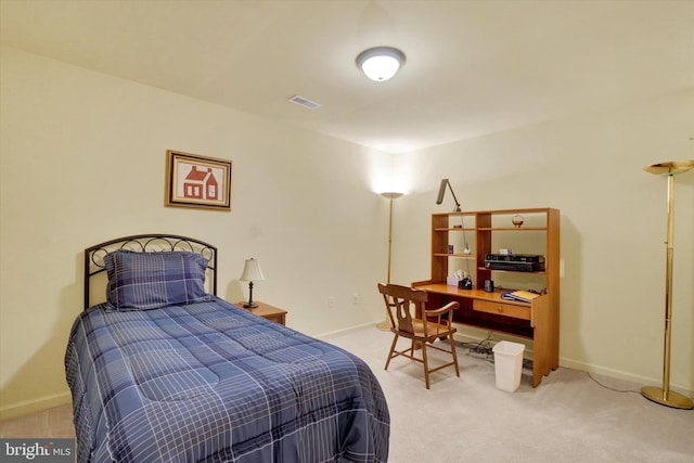 bedroom with baseboards, visible vents, and light colored carpet