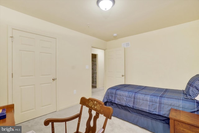 bedroom with light carpet, visible vents, and baseboards