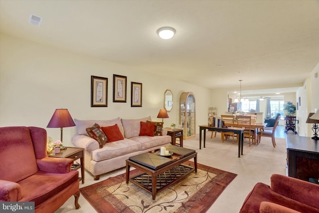 living room featuring visible vents and light colored carpet