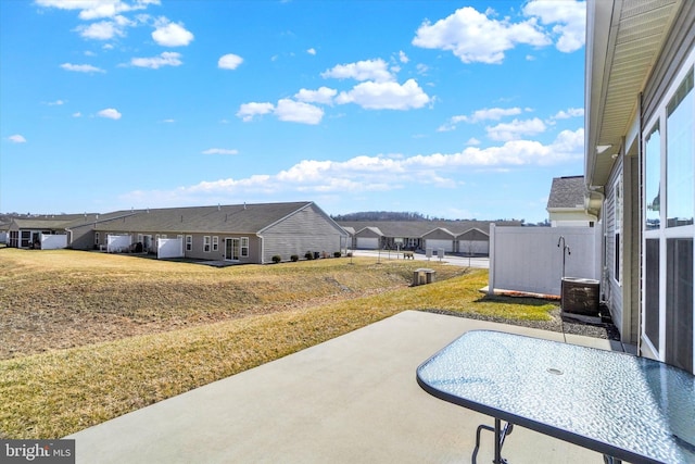 view of swimming pool with a yard, a residential view, fence, and a patio