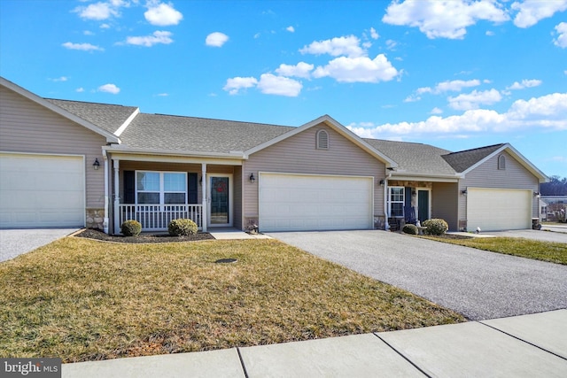 ranch-style house with a shingled roof, covered porch, stone siding, driveway, and a front lawn