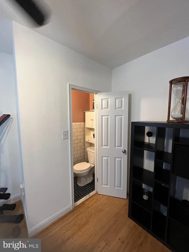 interior space with toilet and wood finished floors