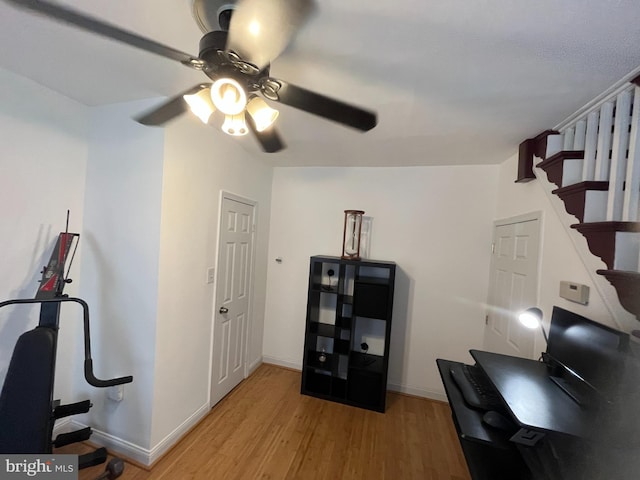 home office with a ceiling fan, light wood-style flooring, and baseboards