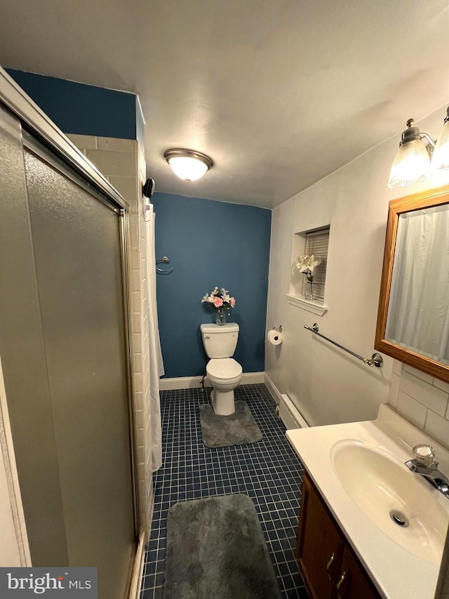 bathroom with toilet, a shower stall, a baseboard radiator, and vanity