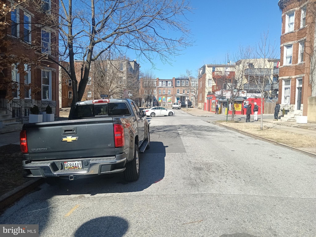 view of street with sidewalks and curbs