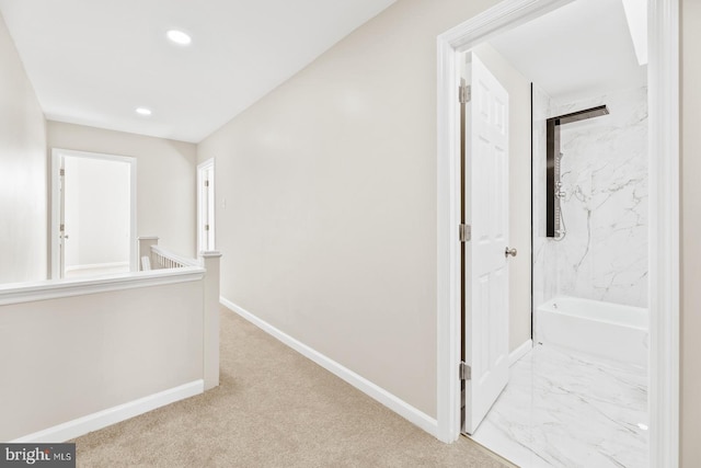 corridor with recessed lighting, marble finish floor, baseboards, and an upstairs landing