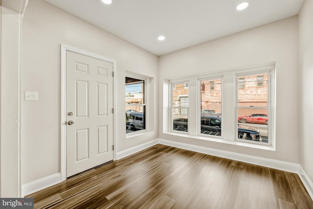 foyer with baseboards, dark wood finished floors, and recessed lighting