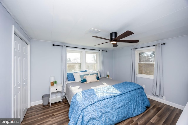 bedroom with visible vents, multiple windows, and wood finished floors